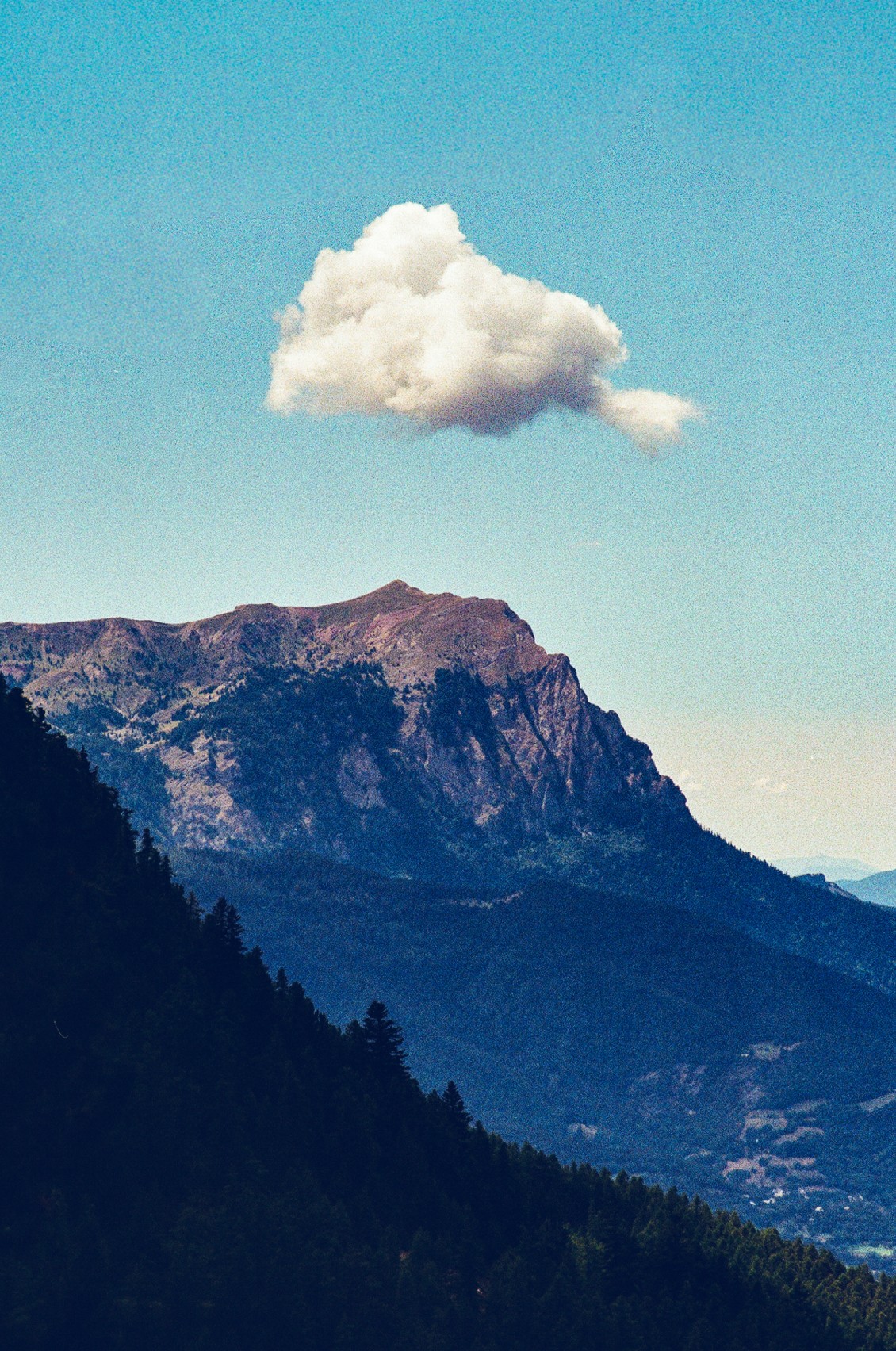 Mountain with a single white cloud above it